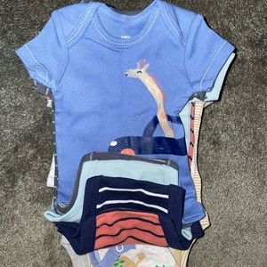 About 10-15 New Born Carters Onsies.